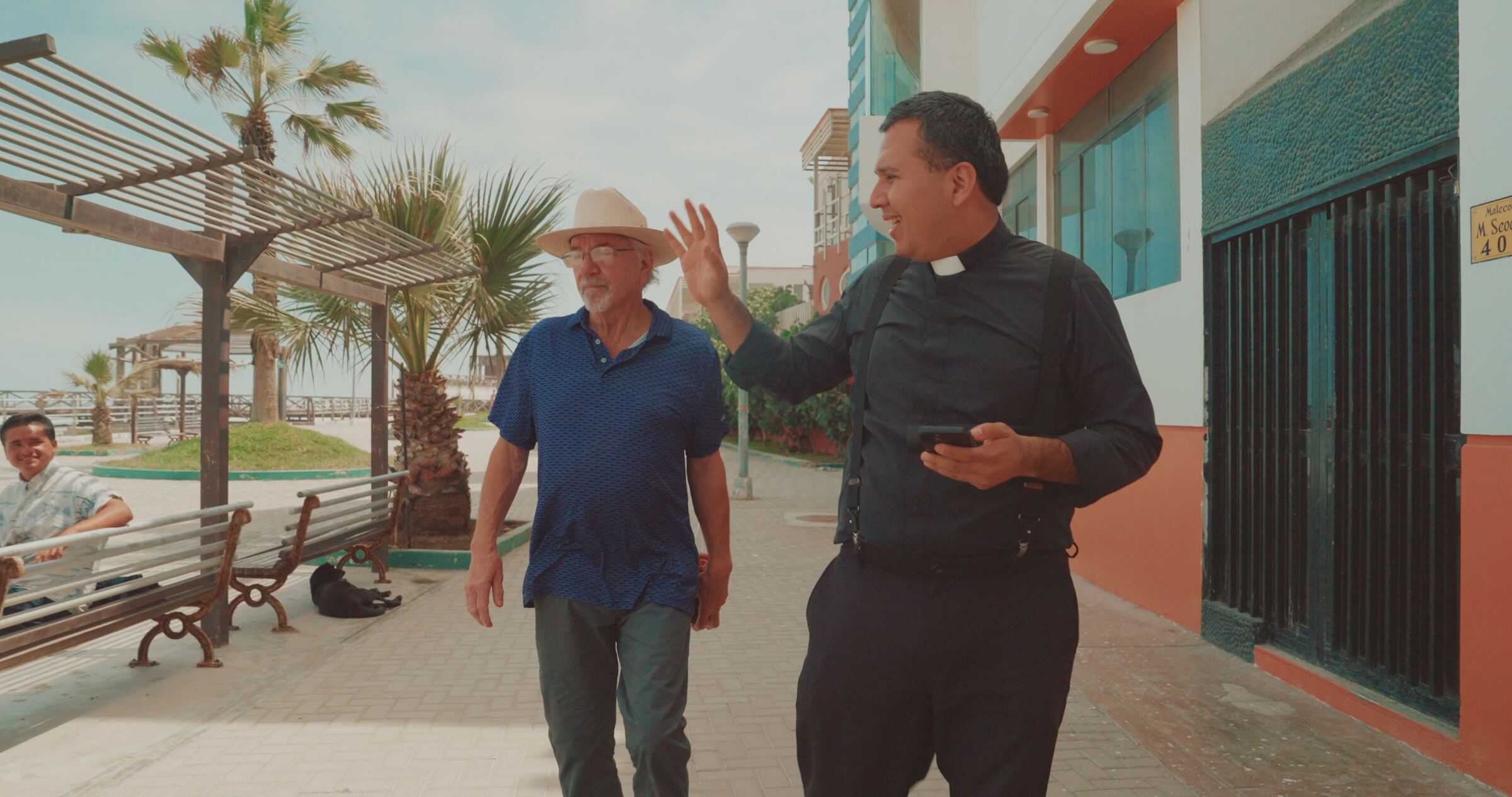 Stan Herd and Father Cesar walking the boardwalk at Pimentel