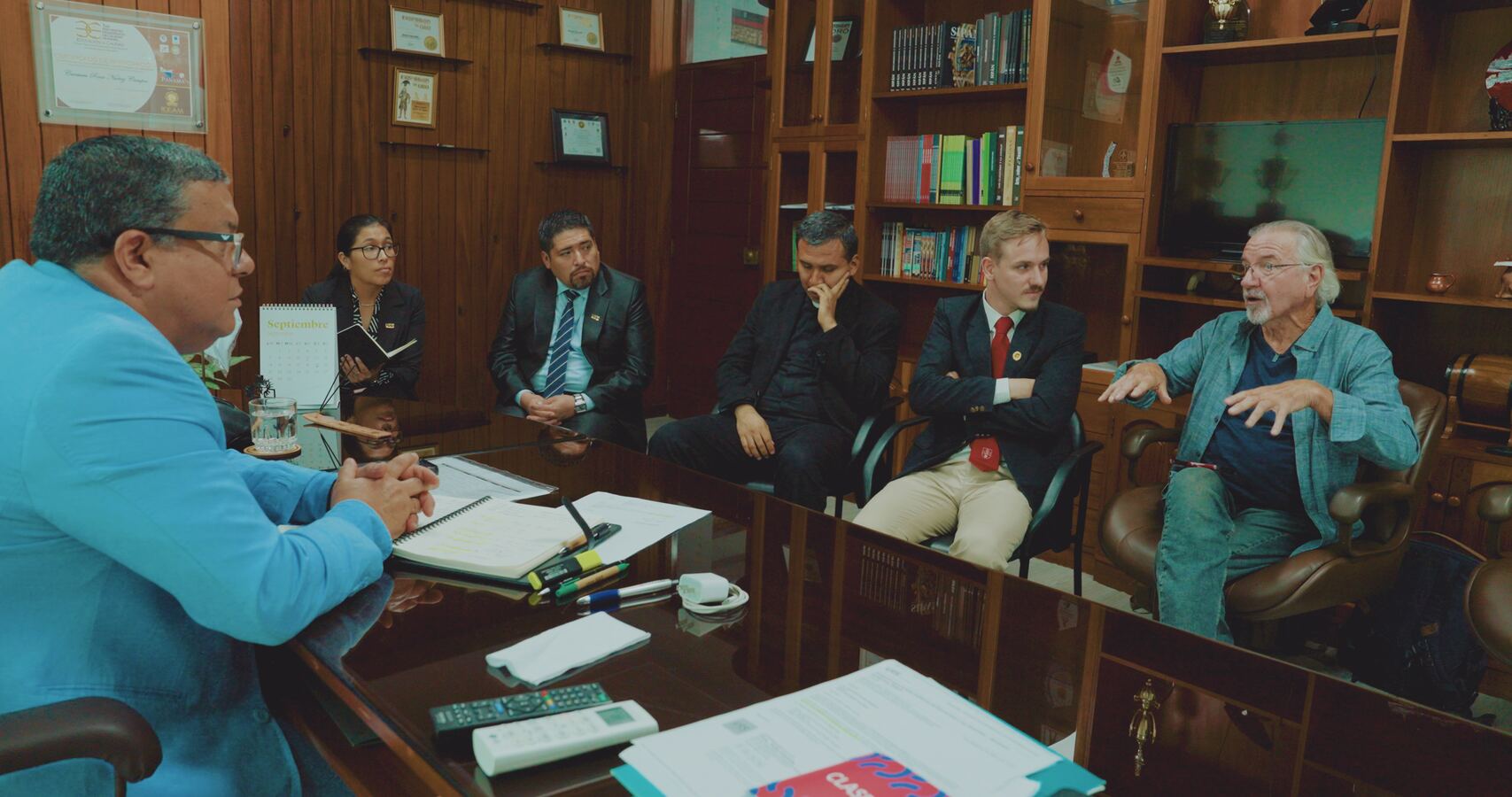 Stan Herd and Louis meeting with leaders around a conference table
